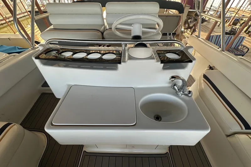 Slide: The Image of 1996 Mainship 40 Sedan Bridge yacht docked in a marina, showcasing spacious deck layout. - 13