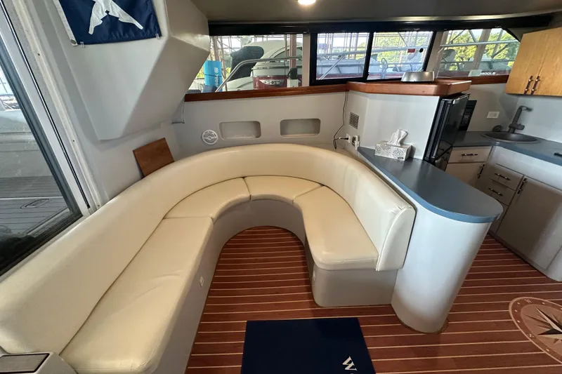 Slide: The Image of 1996 Mainship 40 Sedan Bridge helm with sink, cup holders, and steering wheel. - 14