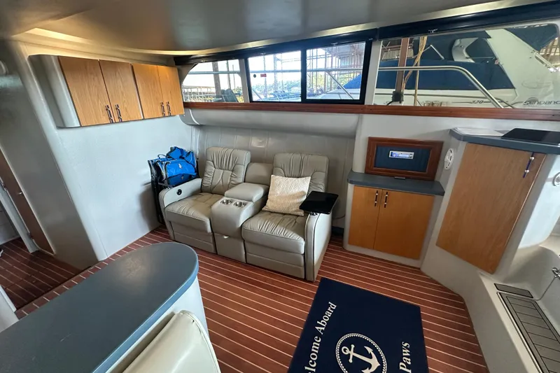 Slide: The Image of 1996 Mainship 40 Sedan Bridge interior with curved seating and kitchenette. - 15