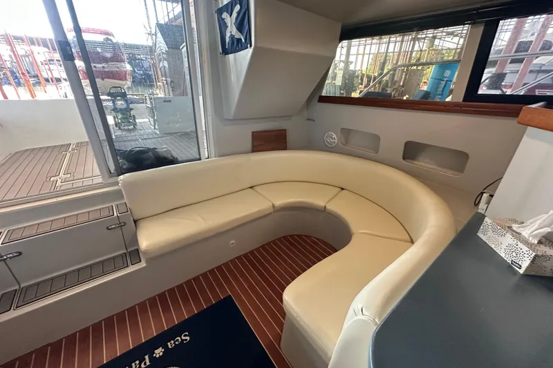 Slide: The Image of Interior of 1996 Mainship 40 Sedan Bridge with leather seating and wooden cabinetry. - 17