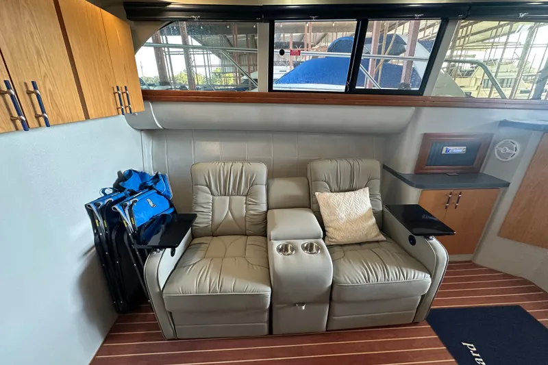 Slide: The Image of Interior of a 1996 Mainship 40 Sedan Bridge yacht with seating and wood accents. - 20