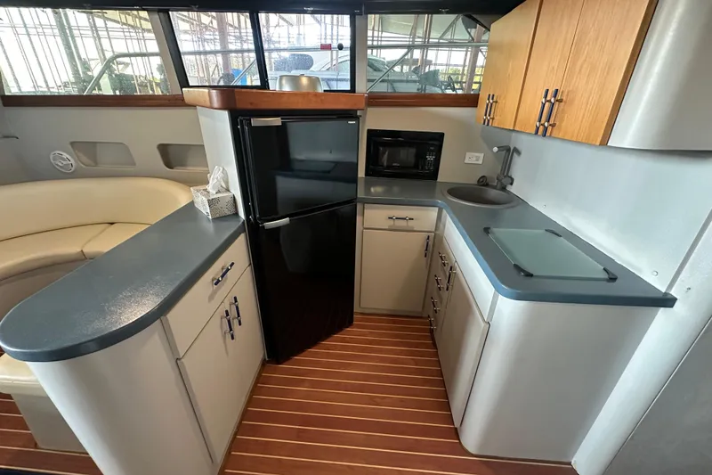 Slide: The Image of Interior of 1996 Mainship 40 Sedan Bridge yacht kitchen with modern appliances. - 22