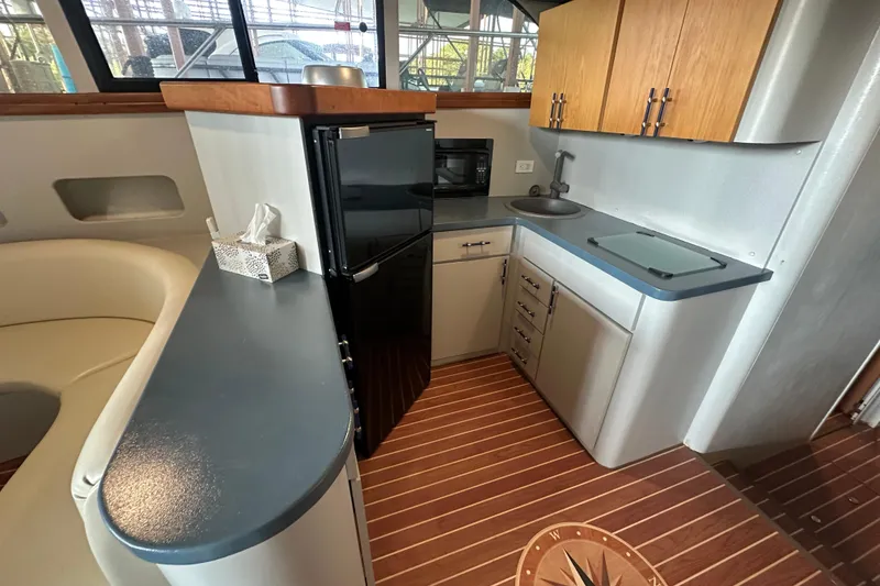 Slide: The Image of 1996 Mainship 40 Sedan Bridge kitchen with modern appliances and sleek cabinetry. - 23
