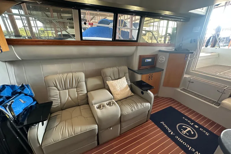 Slide: The Image of 1996 Mainship 40 Sedan Bridge kitchen with sink, microwave, and wooden cabinets. - 26