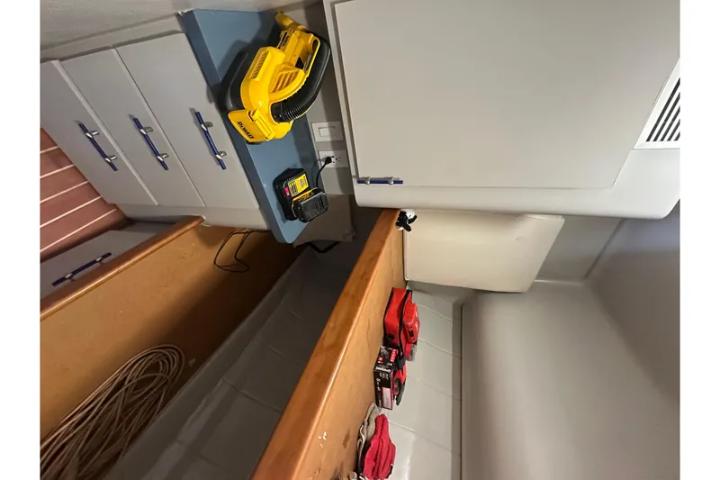 Slide: The Image of Storage area on a 1996 Mainship 40 Sedan Bridge with tools and equipment. - 28