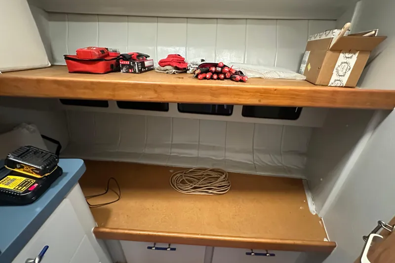 Slide: The Image of Interior of 1996 Mainship 40 Sedan Bridge with tools and storage cabinets. - 29