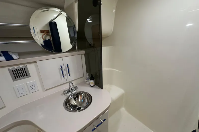 Slide: The Image of 1996 Mainship 40 Sedan Bridge bathroom with sink, toilet, and storage cabinets. - 32