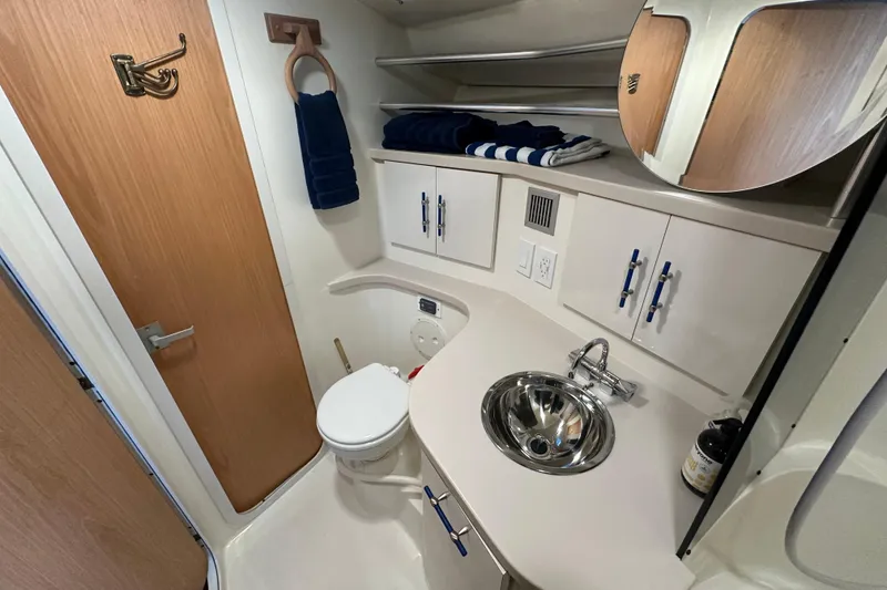 Slide: The Image of Bathroom interior of 1996 Mainship 40 Sedan Bridge with shower and blue towel. - 35