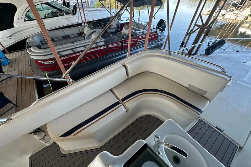 Slide: The Image of 1996 Mainship 40 Sedan Bridge yacht with spacious seating and sink, docked at marina. - 4