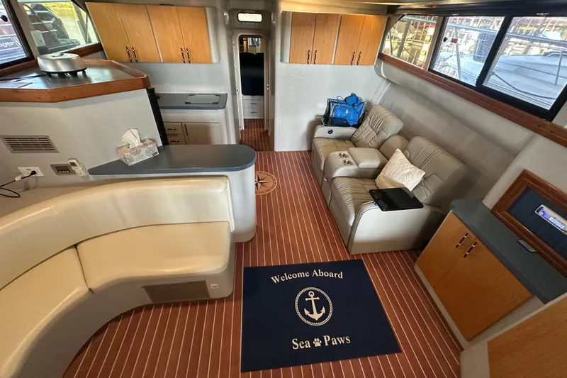 Slide: The Image of Interior of 1996 Mainship 40 Sedan Bridge with seating, kitchenette, and nautical decor. - 45