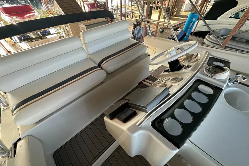 Slide: The Image of 1996 Mainship 40 Sedan Bridge interior with helm, seating, and sink area. - 9