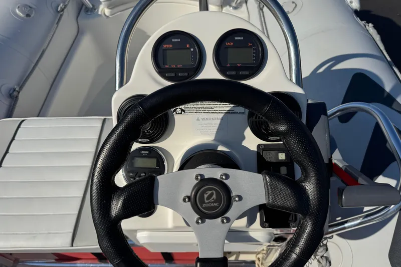 Slide: The Image of Steering console of a 2013 Zodiac 500 Bayrunner boat with gauges and controls. - 10