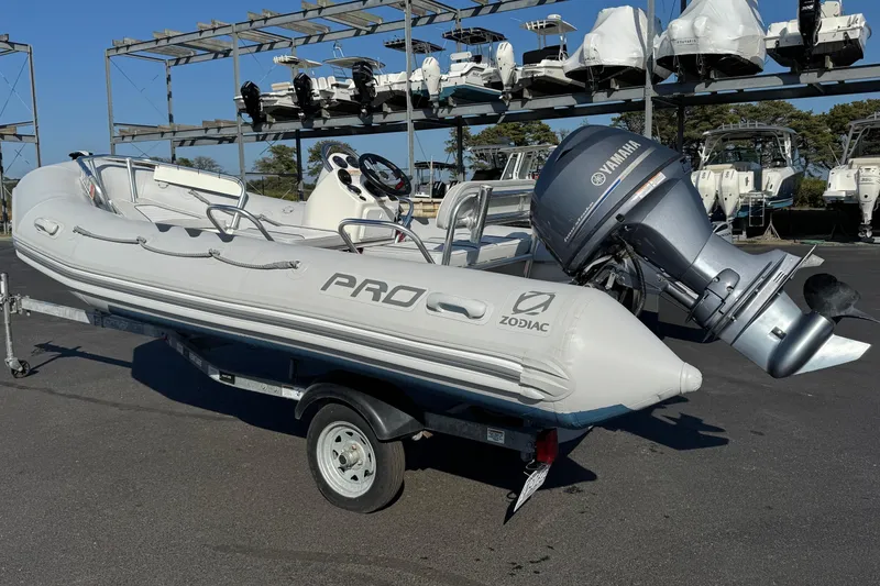 Slide: The Image of 2013 Zodiac 500 Bayrunner inflatable boat with Yamaha outboard motor on a trailer. - 2