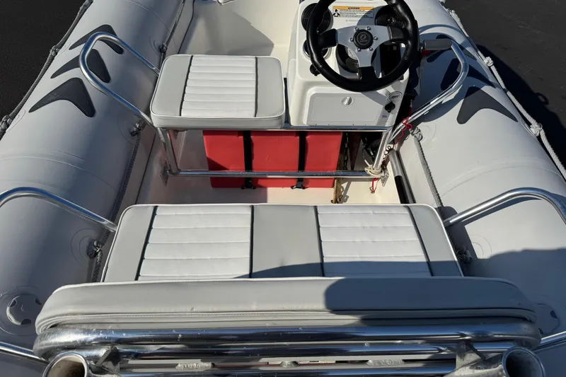 Slide: The Image of 2013 Zodiac 500 Bayrunner inflatable boat interior with steering wheel and seating. - 8