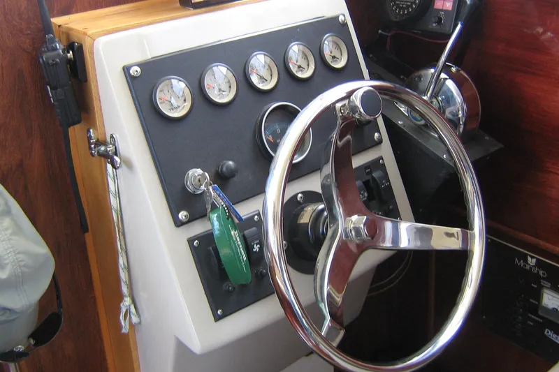Slide: The Image of Steering wheel and dashboard of 1979 Mainship 34 Custom Sedan boat. - 13