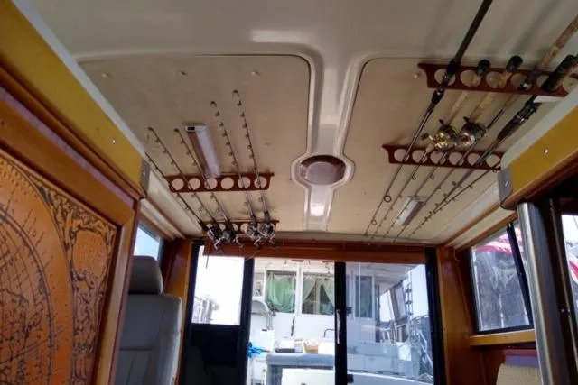 Slide: The Image of Interior of 1979 Mainship 34 Custom Sedan with fishing rods on ceiling racks. - 14