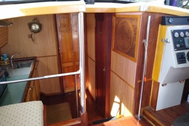 Slide: The Image of Interior of 1979 Mainship 34 Custom Sedan with wood paneling and nautical decor. - 19