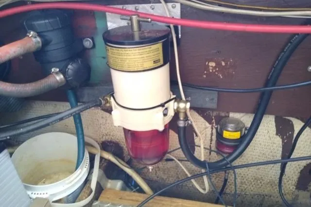 Slide: The Image of Engine compartment of a 1979 Mainship 34 Custom Sedan with fuel filter and hoses. - 30