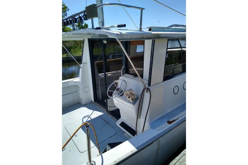 Slide: The Image of 1979 Mainship 34 Custom Sedan boat with open cockpit and steering wheel. - 5