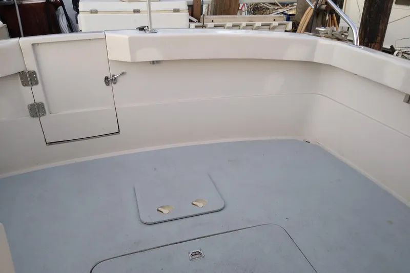 Slide: The Image of 1979 Mainship 34 Custom Sedan boat interior with clean deck and storage hatch. - 8