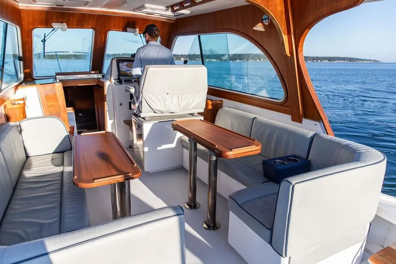 Slide: The Image of Interior of 2012 Hunt Yachts Harrier 36 Express with elegant seating and wooden accents. - 1