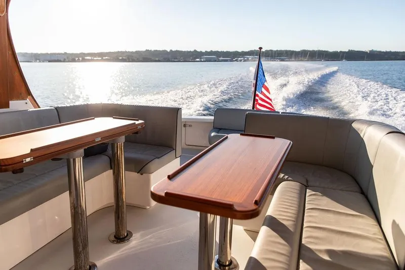 Slide: The Image of Luxurious 2012 Hunt Yachts Harrier 36 Express interior with elegant seating and wooden tables. - 11