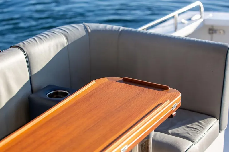 Slide: The Image of Luxury seating area on 2012 Hunt Yachts Harrier 36 Express with wooden table. - 12
