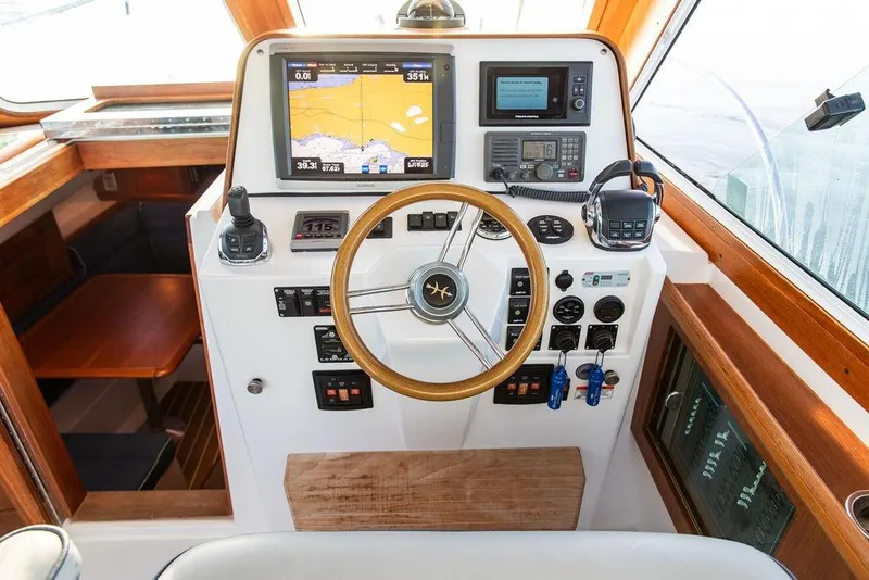 Slide: The Image of Helm of 2012 Hunt Yachts Harrier 36 Express with navigation equipment and wooden accents. - 14