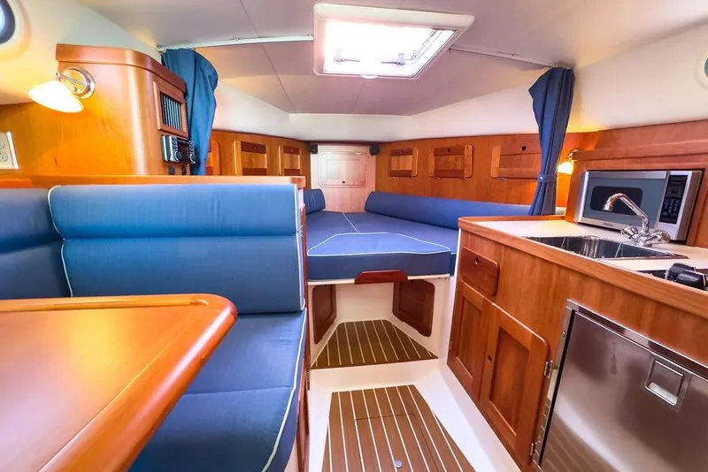 Slide: The Image of Luxurious 2012 Hunt Yachts Harrier 36 Express interior with wood finish and blue seating. - 20