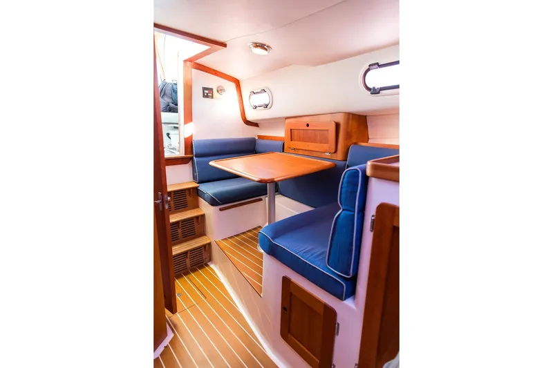 Slide: The Image of Interior of 2012 Hunt Yachts Harrier 36 Express with blue seating and wooden accents. - 22