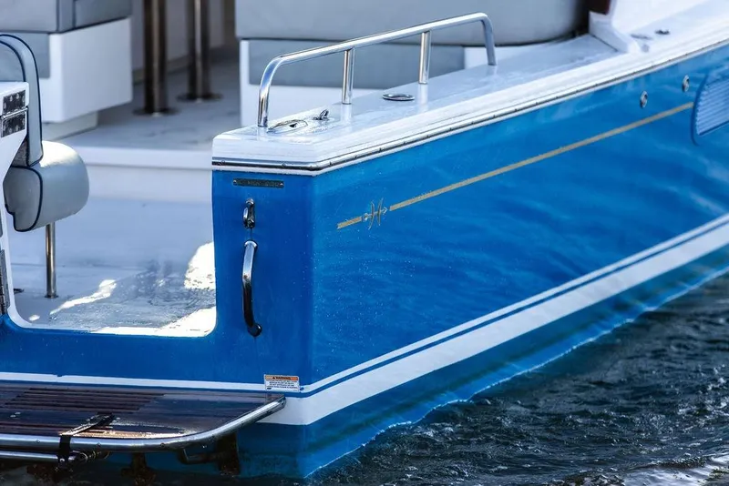 Slide: The Image of 2012 Hunt Yachts Harrier 36 Express, blue hull detail, docked on water. - 6