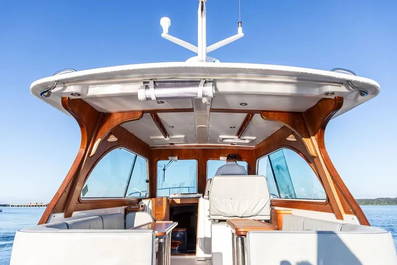 Slide: The Image of 2012 Hunt Yachts Harrier 36 Express interior with wood accents and seating. - 8