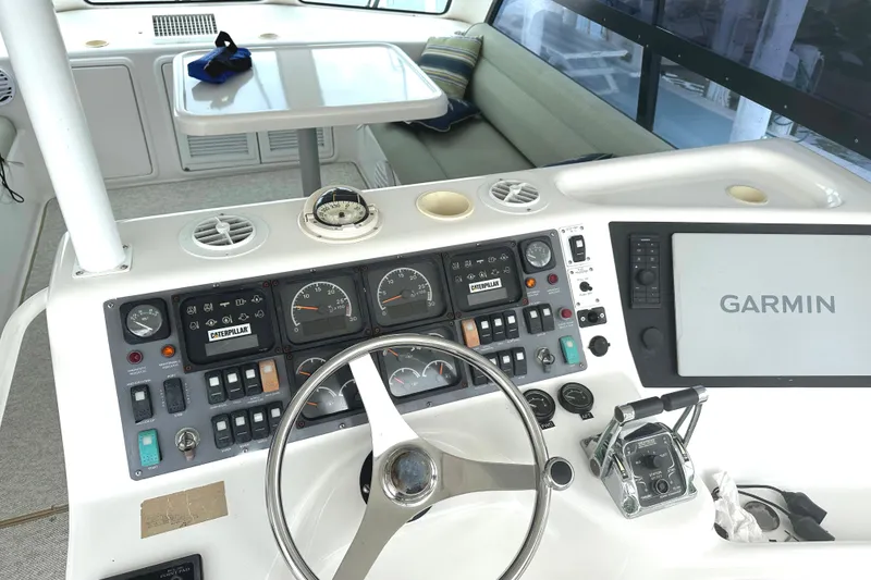 Slide: The Image of 1999 Riviera Convertible SF boat dashboard with Garmin navigation system and control panel. - 12