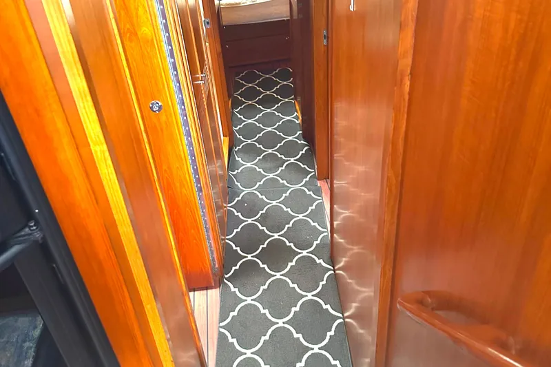 Slide: The Image of Narrow hallway in 1999 Riviera Convertible SF with wooden paneling and patterned carpet. - 21