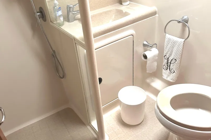 Slide: The Image of Compact bathroom in 1999 Riviera Convertible SF, featuring shower, sink, and toilet. - 22