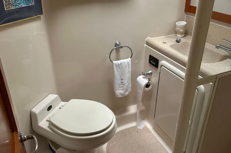 Slide: The Image of 1999 Riviera Convertible SF bathroom with toilet, sink, and towel. - 23