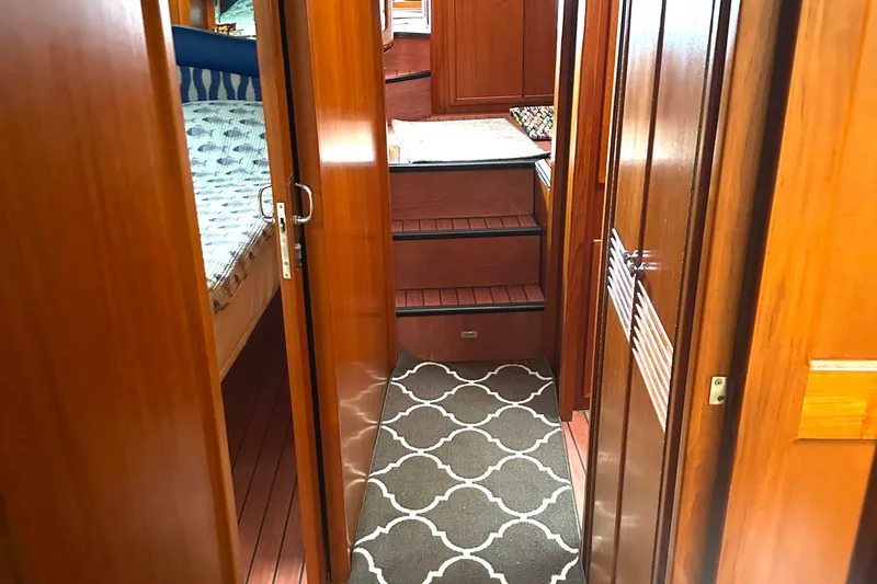 Slide: The Image of Interior of 1999 Riviera Convertible SF yacht with wooden finishes and patterned carpet. - 24