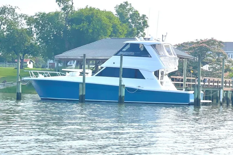 Slide: The Image of 1999 Riviera Convertible SF yacht docked by a scenic waterfront. - 7