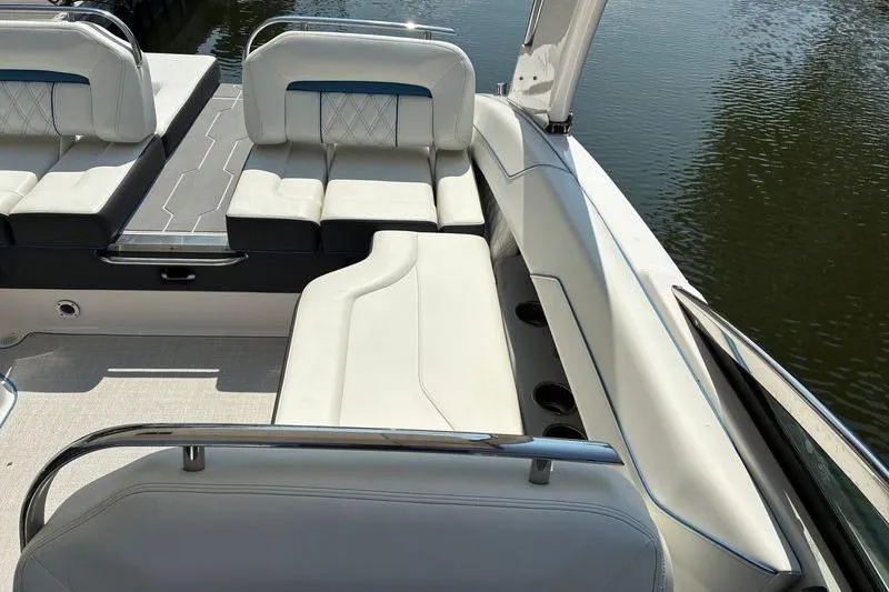 Slide: The Image of Luxurious seating on a 2020 Regal LS4 boat, featuring elegant white upholstery by the water. - 10