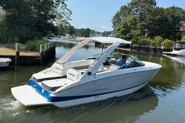 Slide: The Image of 2020 Regal LS4 boat cruising in a scenic, tree-lined waterway. - 3