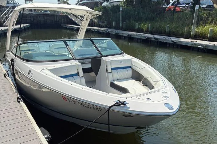 Slide: The Image of 2020 Regal LS4 boat docked in a marina, featuring sleek design and spacious seating. - 4