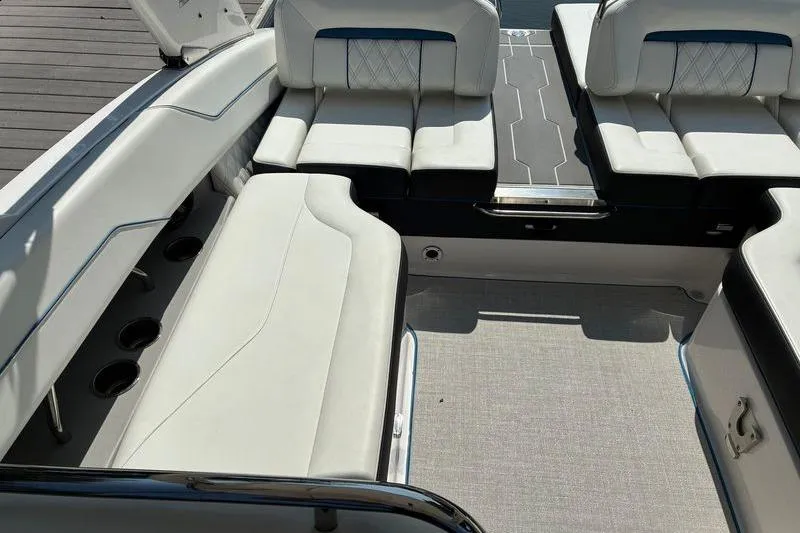 Slide: The Image of 2020 Regal LS4 boat interior with luxurious white seating and cup holders. - 8
