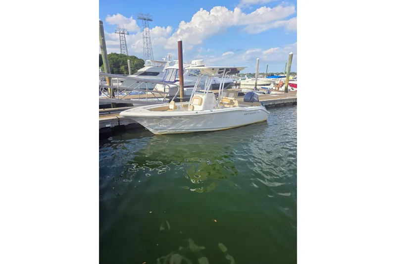 The Image of 2020 Key West 219 FS boat docked at marina under blue sky. - 12