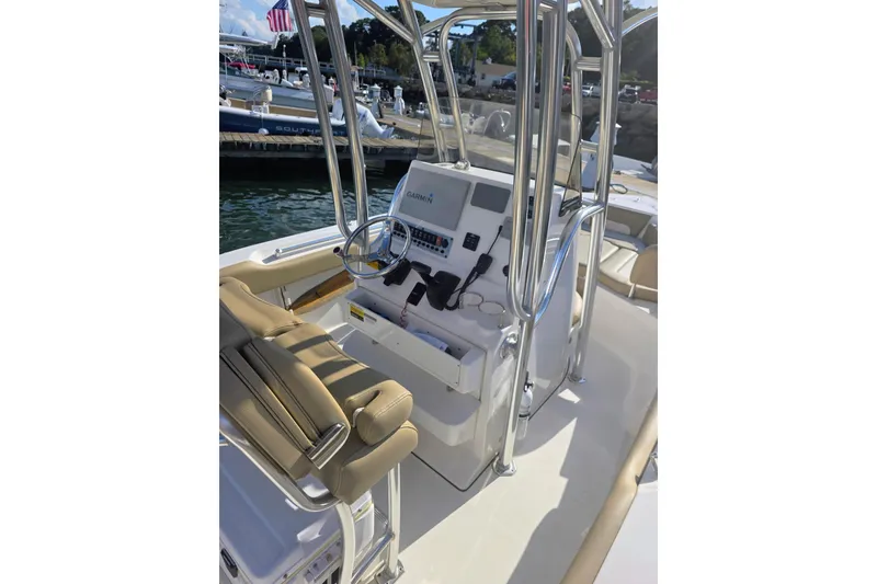 Slide: The Image of 2020 Key West 219 FS boat interior with steering console and seating. - 14