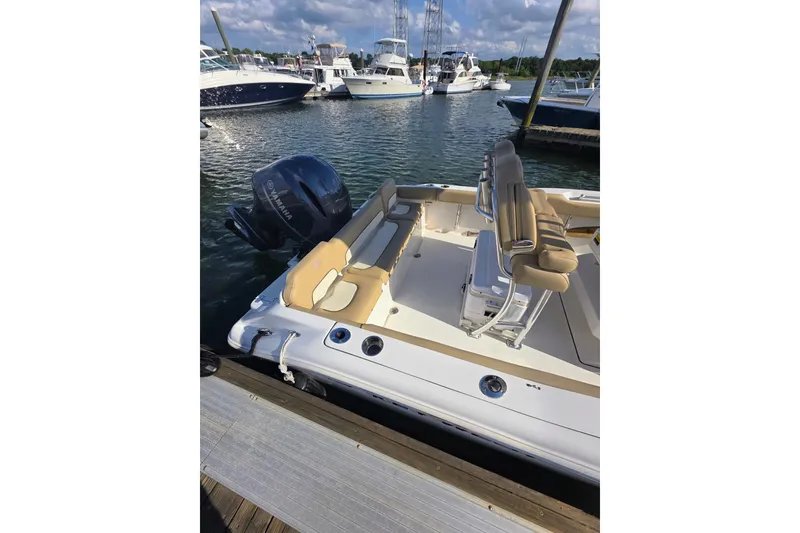 Slide: The Image of 2020 Key West 219 FS boat docked, featuring Yamaha outboard motor and beige seating. - 15