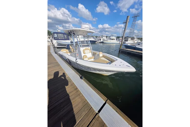 Slide: The Image of 2020 Key West 219 FS boat docked at marina under blue sky. - 18