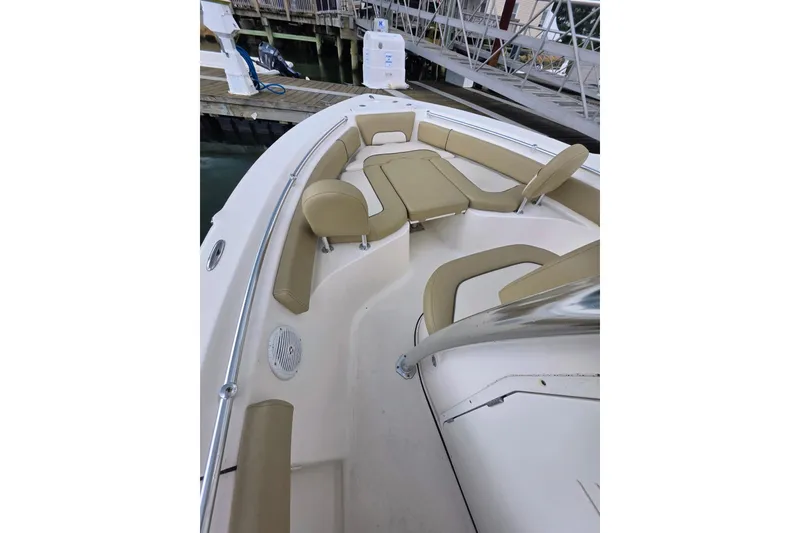 Slide: The Image of 2020 Key West 219 FS boat interior with beige seating and stainless steel railings. - 20