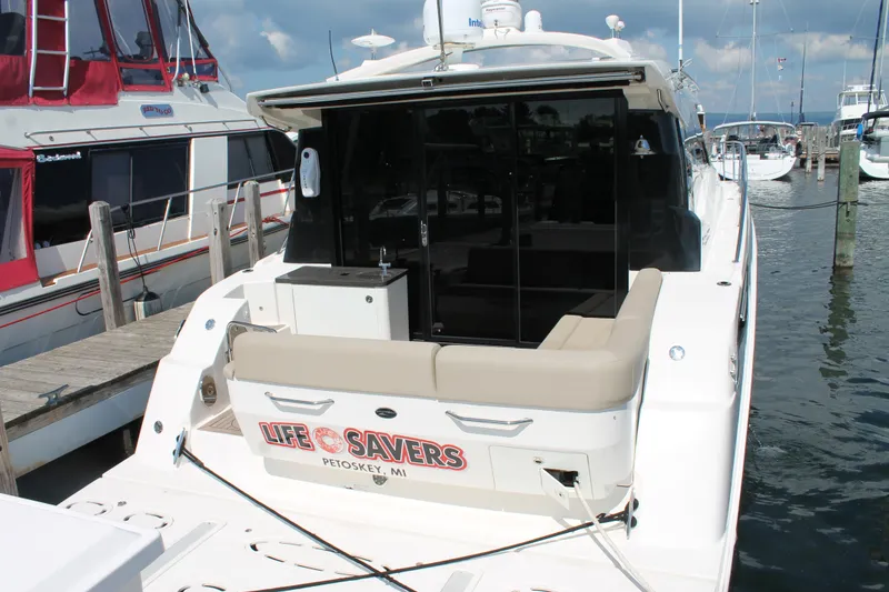 Slide: The Image of 2015 Sea Ray 470 Sundancer yacht docked at marina, rear view. - 1