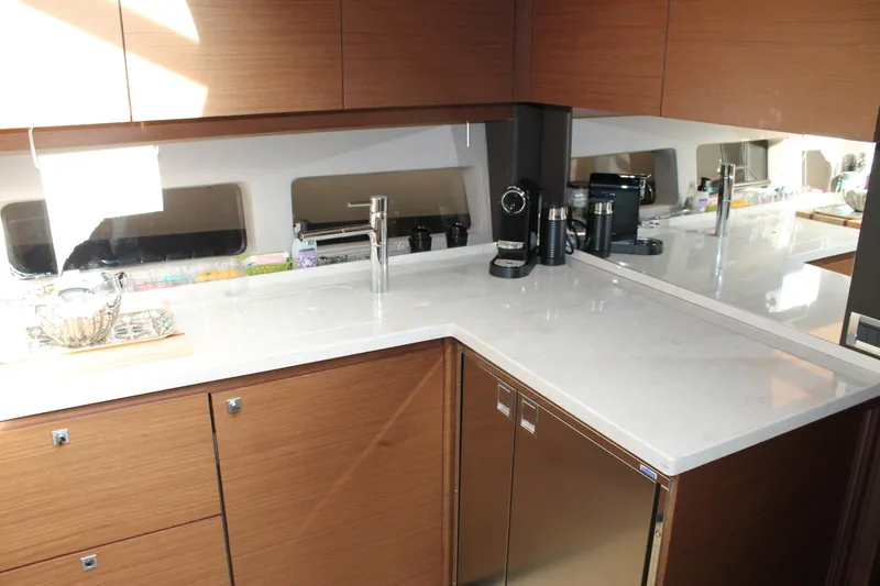 Slide: The Image of Modern kitchen interior of 2015 Sea Ray 470 Sundancer yacht with sleek countertops and appliances. - 108