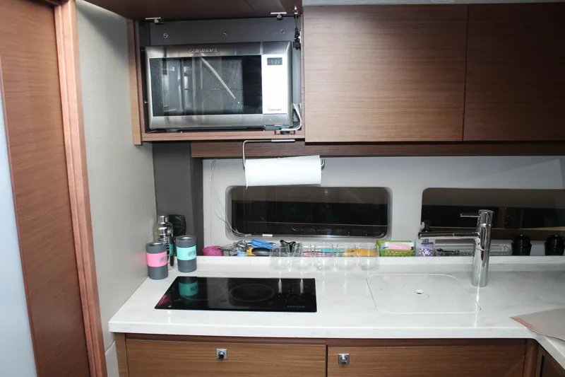 Slide: The Image of Modern kitchen in 2015 Sea Ray 470 Sundancer yacht with microwave and sleek cabinetry. - 109